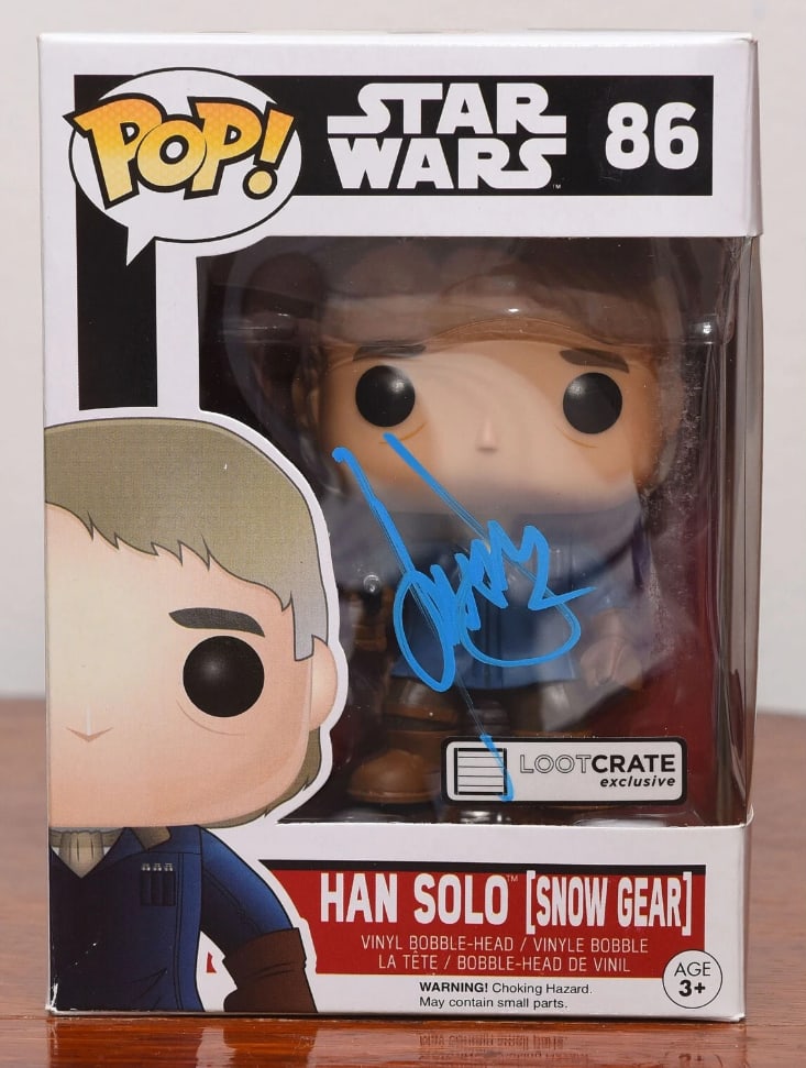 Star Wars: Harrison Ford Signed Han Solo {Snow Gear} Funko Pop #86 (Beckett Authentication): "Star Wars" Han Solo Funko Pop #86 signed on the front plastic window in blue felt tip marker by actor Harrison Ford. Measuring approximately 6.25" x 4.5" x 3.5" and in fine condition. Accompanied by 
