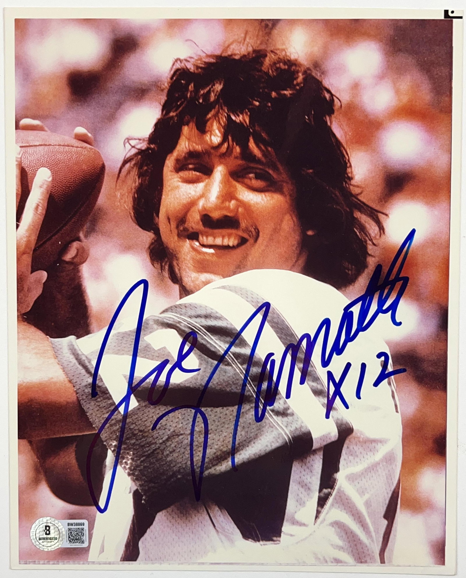 Joe Namath Signed 10" x 8" Photo (Beckett Authentication): Color 10" x 8" photo signed in blue felt tip marker by New York Jets football player Joe Namath, who also inscribed "X 12" his jersey number, after his signature. In fine condition. Authenticated by