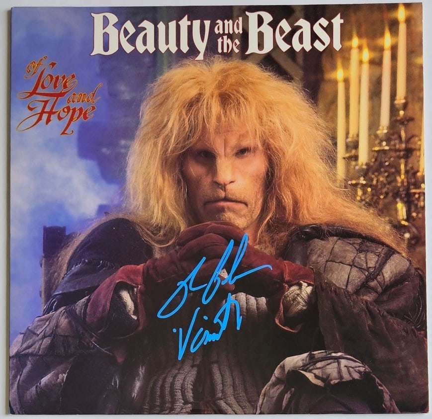 Ron Perlman Signed "Beauty & the Beast" Soundtrack Album (Third Party Guaranteed): "Beaty & the Beast" soundtrack album signed on the cover in blue paint pen by actor Ron Perlman, who also inscribed his character's name "Vincent" after his signature. Measuring approximately 12" x