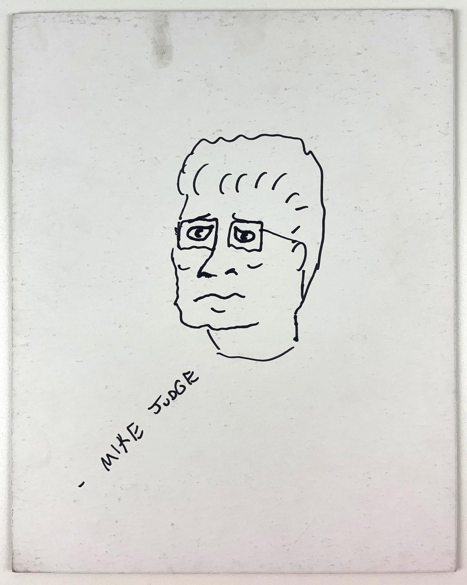 King of the Hill: Mike Judge Signed Hank Hill Drawing (Beckett Authentication): White 14" x 11" drawing on matte board of the character Hank Hill from the television show "King of the Hill" signed in black felt tip marker by cartoonist Mike Judge. In fine condition. Authenticated