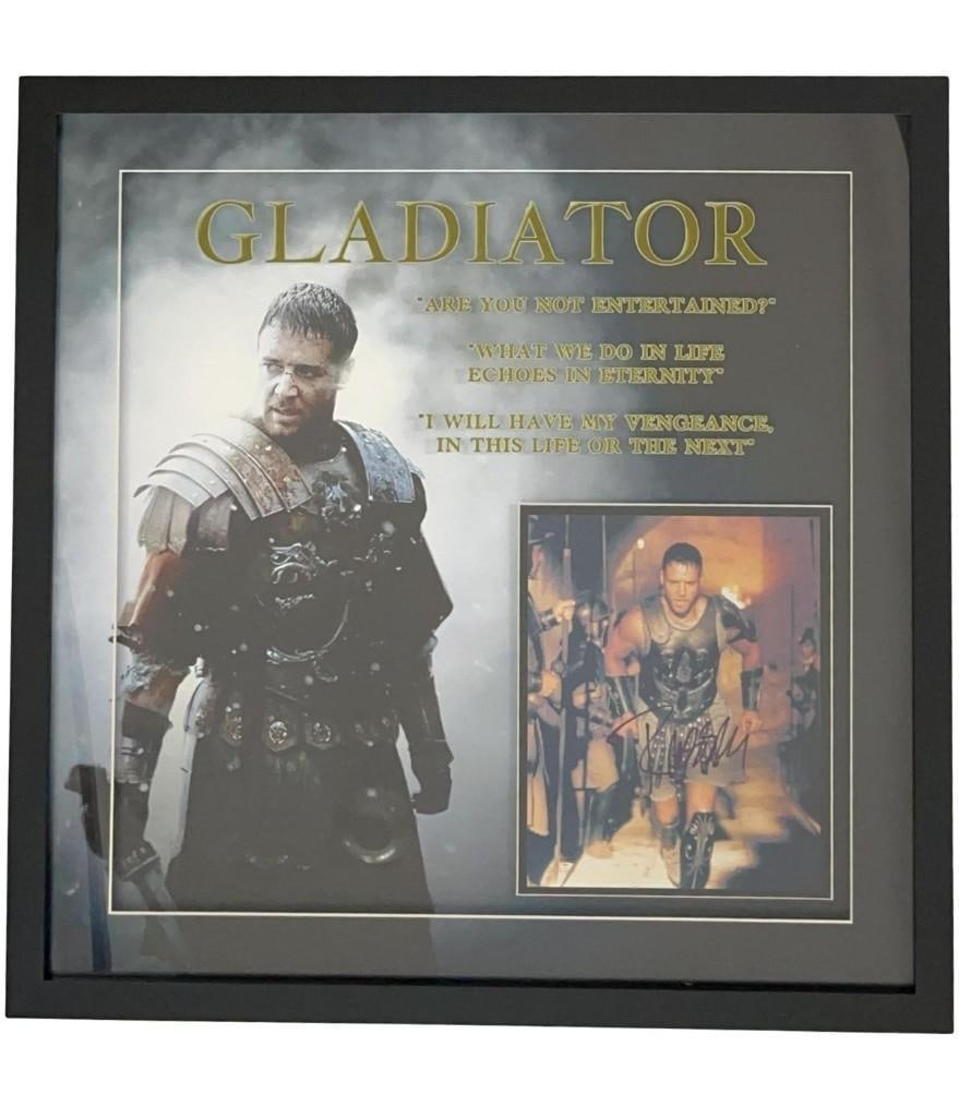 Gladiator: Russel Crowe Signed Framed Photo (Third Party Guaranteed): Color photo from the film "Gladiator" signed in black felt tip marker by actor Russell Crowe. Signed photo measured 9.5" x 8" and is presented in a frame measuring 25.5" x 25.5" overall. In fine condi