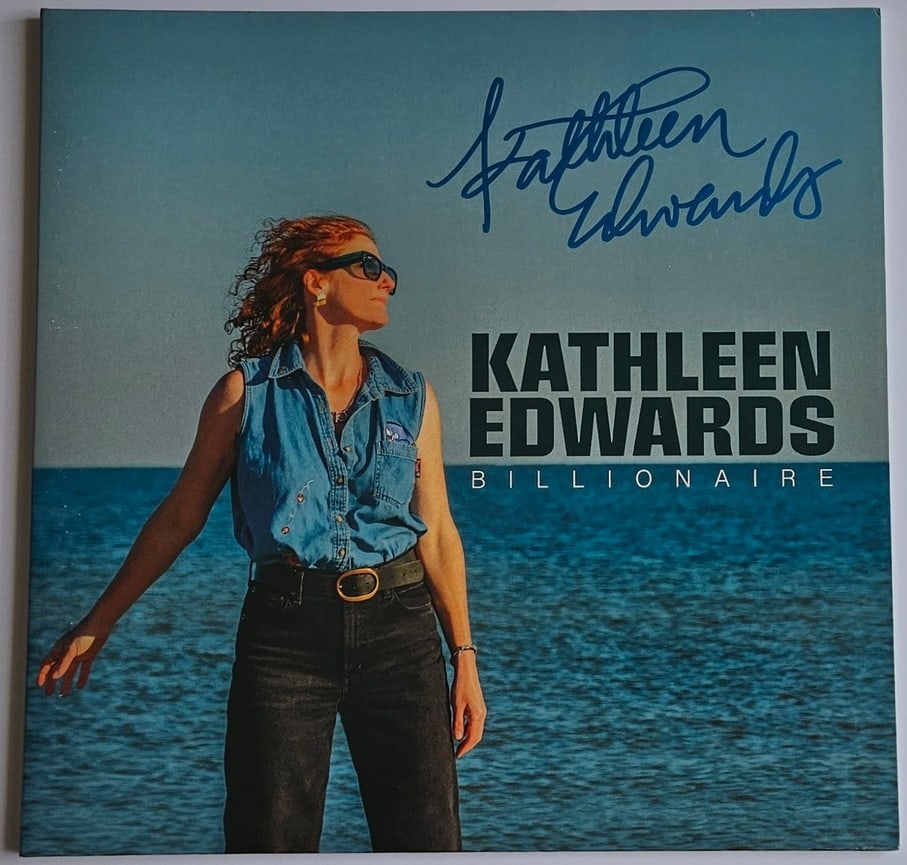 Kathleen Edwards Signed "Billionaire" Album (Third Party Guaranteed): "Billionaire" album signed on the cover in blue felt tip marker by musician Kathleen Edwards. Measuring approximately 12" x 12" and in fine condition. Record is not included. Provenance Eaton & Brenna