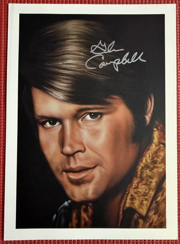 Glen Campbell Signed 10" x 8" Drawing (PSA/DNA Authentication): Color 10" x 8" drawing signed in silver felt tip marker by actor Glen Campbell. In fine condition. Authenticated by PSA/DNA, with their official hologram affixed to the back bottom left corner (#AQ661