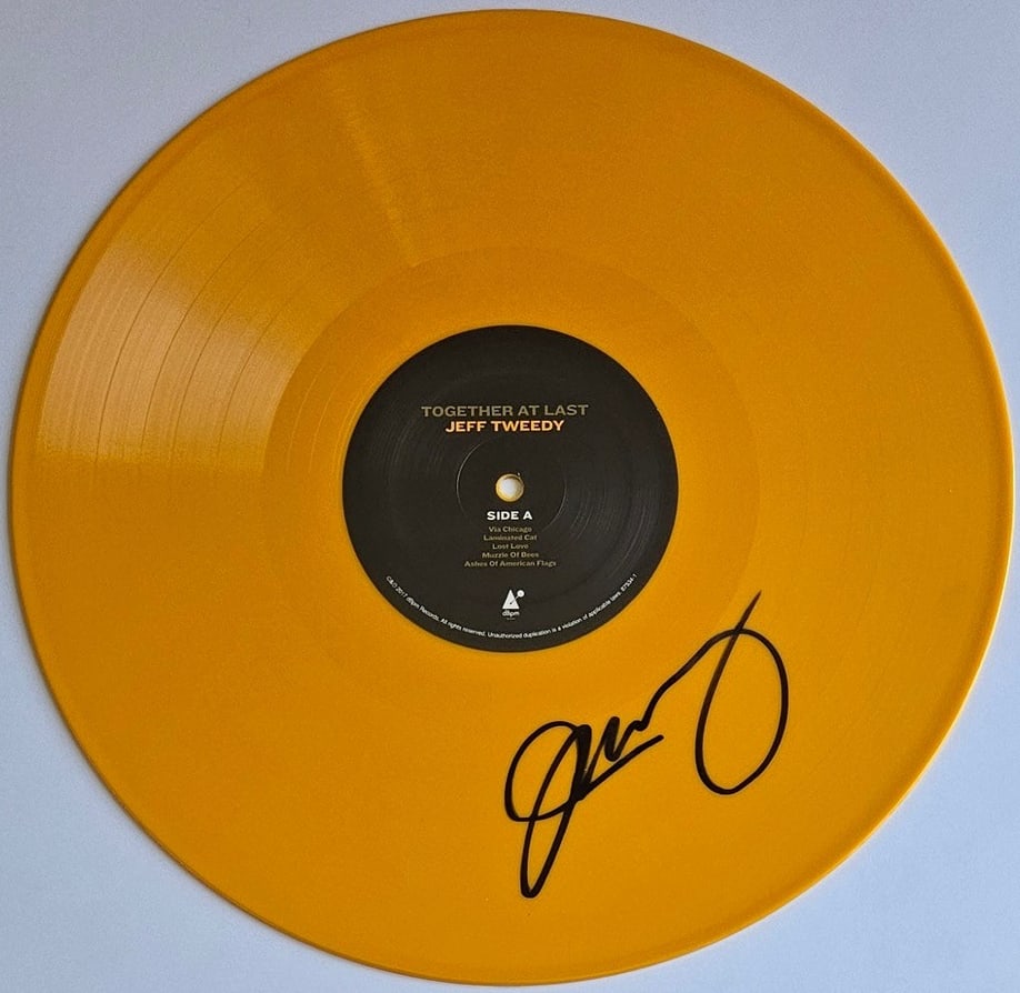 Wilco: Jeff Tweedy Signed "Together at Last" Record Disc (Third Party Guaranteed): "Together at Last" vinyl disc signed in black felt tip marker by Wilco band member Jeff Tweedy. Measuring approximately 12" x 12" and in fine condition. Provenance Eaton & Brennan Auctions guarantees 