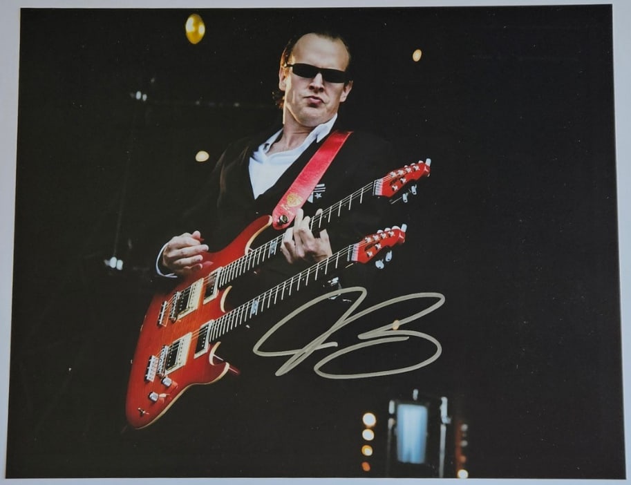 Joe Bonamassa Signed 11" x 14" Photo (Third Party Guaranteed): Color 11" x 14" photo signed in silver felt tip marker by musician Joe Bonamasssa. In fine condition. Provenance Eaton & Brennan Auctions guarantees this lot to pass Third-Party Authentication. Please