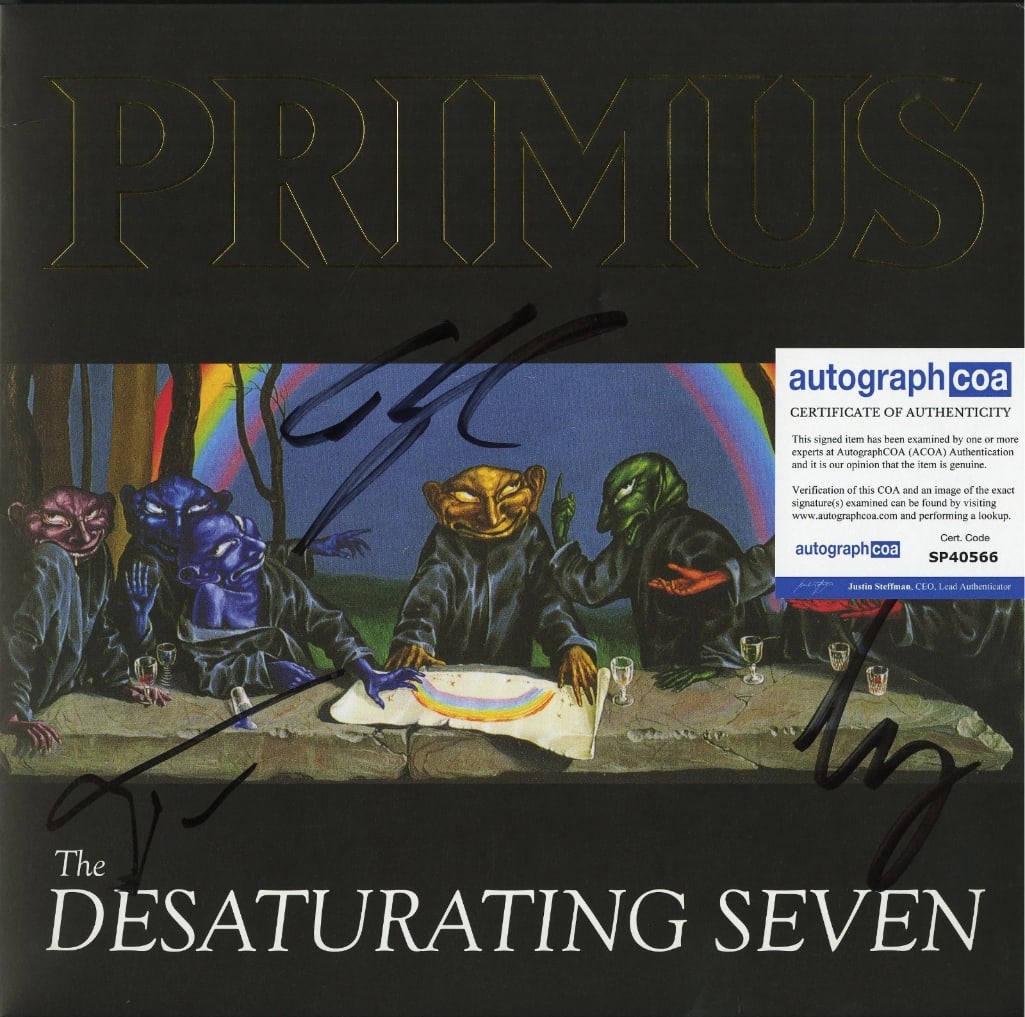 Primus Group Signed "The Desaturating Seven" Album (3 Sigs) (ACOA): "The Desaturating Seven" album signed on the cover in black felt tip marker by Primus band members Les Claypool, Larry LaLonde, and Tim Alexander. Measuring approximately 12" x 12" and in fine