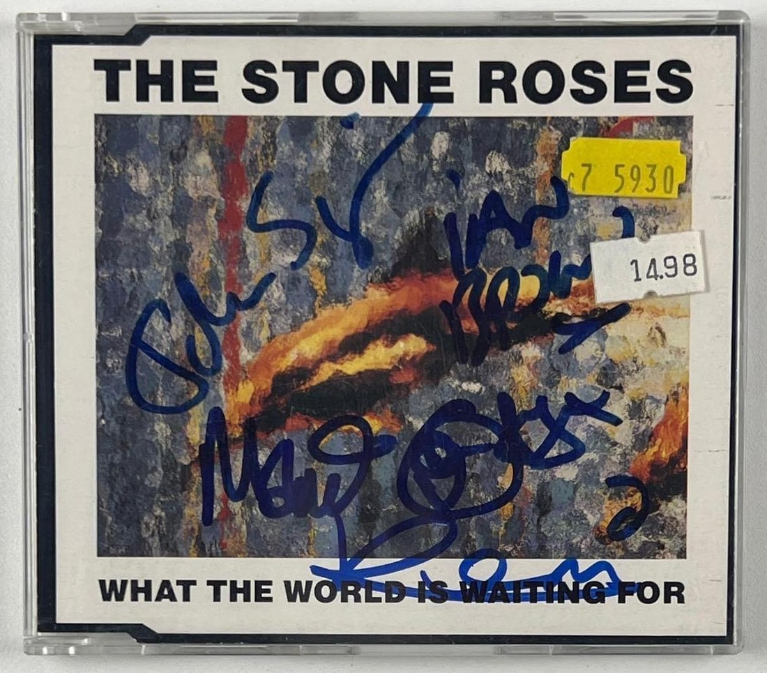 The Stone Roses Fully Group Signed "What the World is Waiting For" CD (4 Sigs): "What the World is Waiting For" CD signed on the cover in blue felt tip marker by The Stone Roses band members Ian Brown, John Squire, Mani Mounfield, and Reni Wren. Measuring approximately 5" x 5"