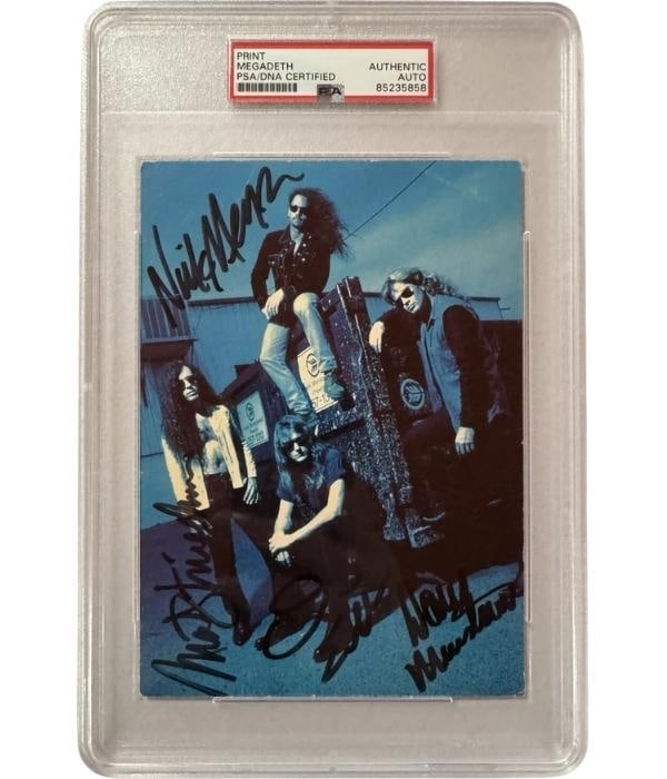 Megadeth Group Signed 7" x 5" Photo (4 Sigs) (PSA/DNA Encapsulated): Color 7" x 5" photo signed in black felt tip marker by Megadeth band members Dave Mustaine, David Ellefson, Marty Friedman, and Nick Menza. In fine condition. Encapsulate and authenticated by PSA/DNA 