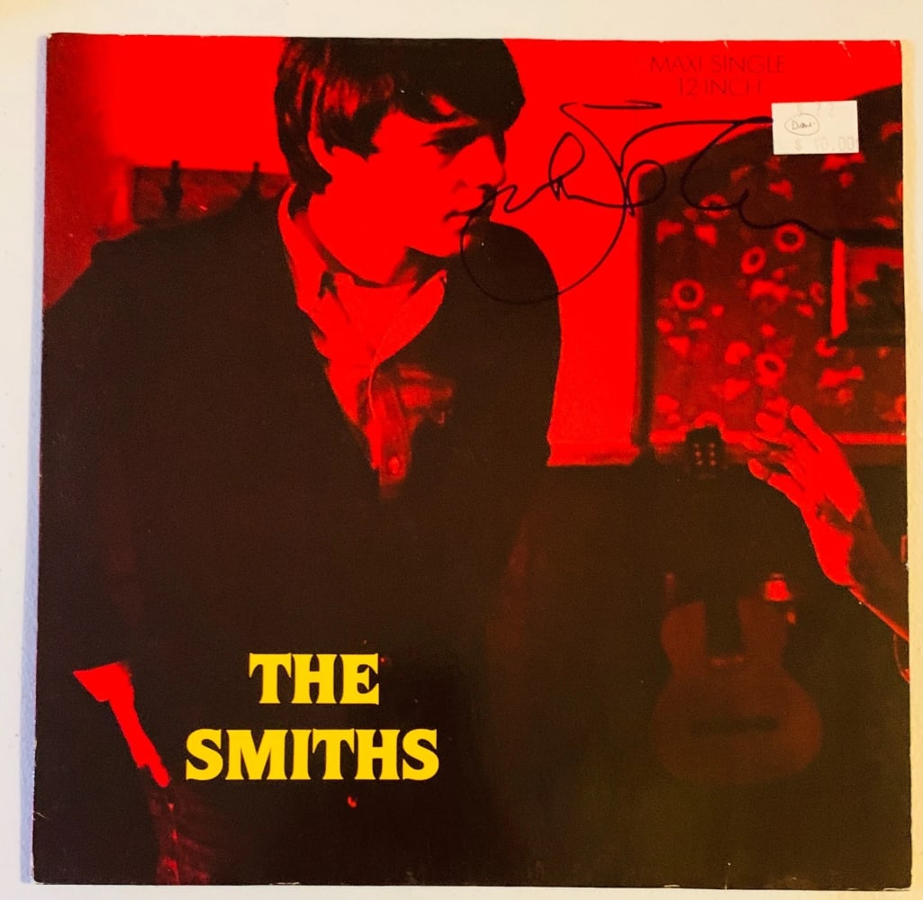 The Smiths: Johnny Marr Signed "Stop Me" EP Album (Beckett Authentication): "Stop Me" EP album signed on the cover in blue felt tip marker by The Smiths band member Johnny Marr. Measuring approximately 12" x 12" and in fine condition. Record is included. Obtained in-person.