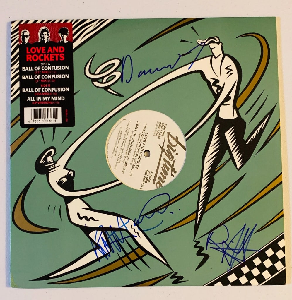 Love and Rockets Fully Group Signed "Ball of Confusion" Album (3 Sigs) (JSA): "Ball of Confusion" album signed on the cover in blue felt tip marker by Love and Rockets band members Daniel Ash, David J, and Kevin Haskins. Measuring approximately 12" x 12" and in fine condition.
