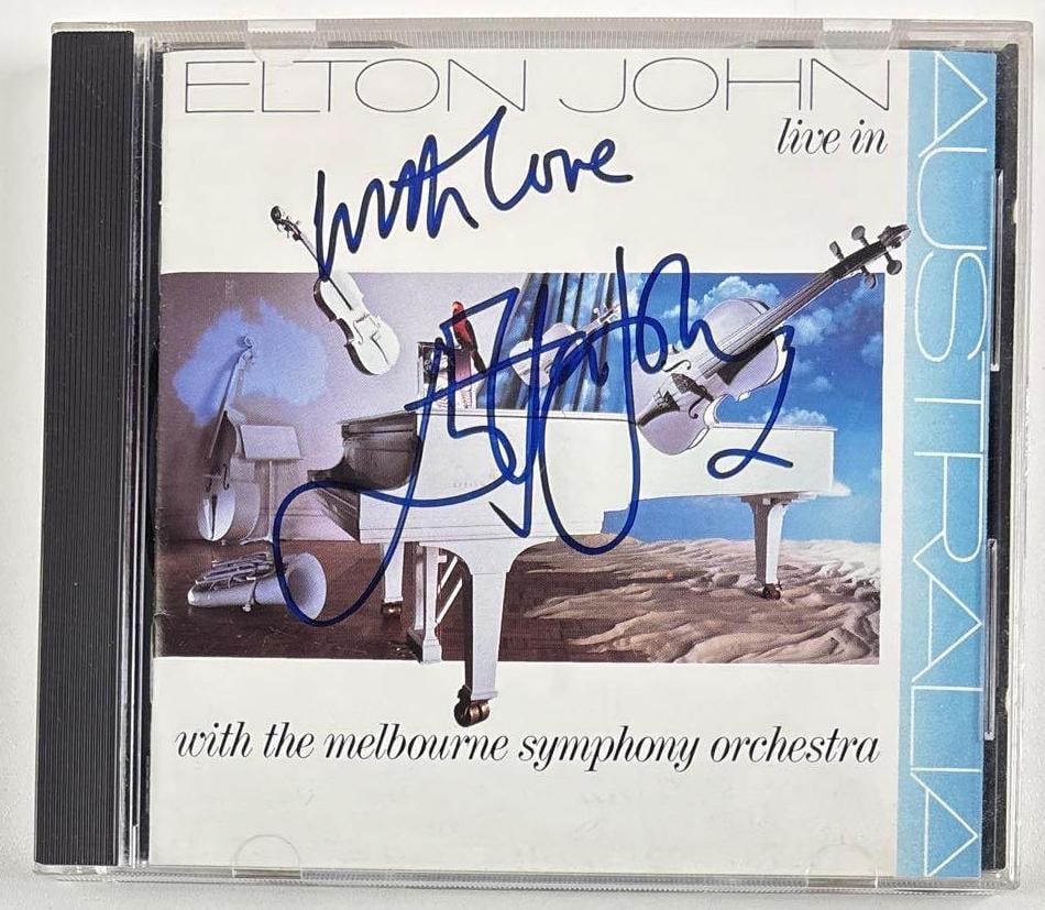 Elton John Signed "Elton John Live in Australia" CD (Third Party Guaranteed): "Elton John Live in Australia" CD signed on the cover in blue felt tip marker by musician Elton John, who inscribed "With love" before his signature. Measuring approximately 5" x 5" and in fine condit