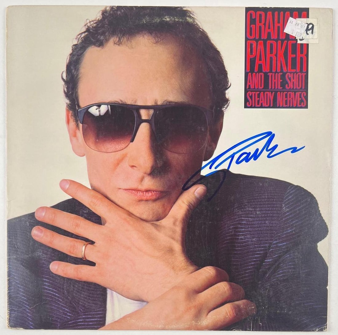 Graham Parker & the Shot: Graham Parker Signed "Steady Nerves" Album (Beckett Authentication): "Steady Nerves" album signed on the cover in blue felt tip marker by Graham Parker & the Shot front man Graham Parker. Measuring approximately 12" x 12" and in fine condition. Record is included.
