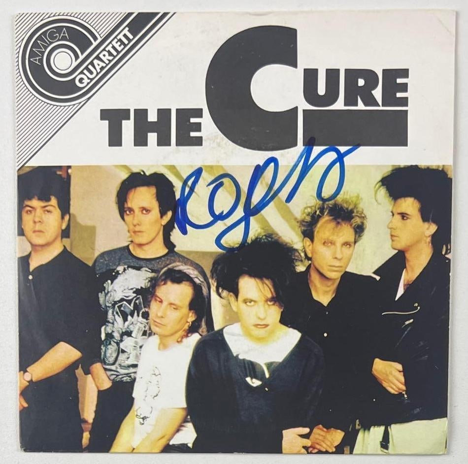 The Cure: Robert Smith Signed East Germany Release "The Cure" 45 (Beckett): "The Cure" 45 East Germany release signed on the cover in blue felt tip marker by The Cure front man Robert Smith. Measuring approximately 7" x 7" and in fine condition. Record is included. Obtained i