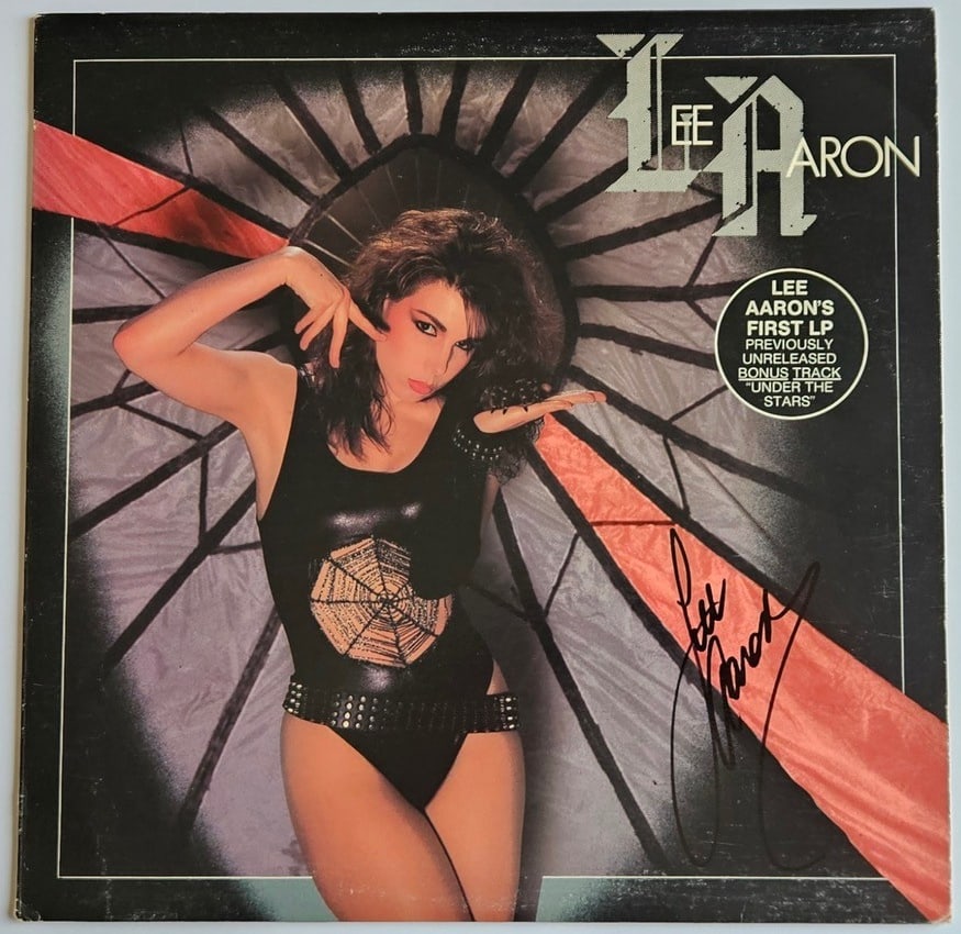 Lee Aaron Signed Self-Titled Album (Third Party Guaranteed): "Lee Aaron" album signed on the cover in black felt tip marker by musician Lee Aaron. Measuring approximately 12" x 12" and in fine condition. Record is included. Provenance Eaton & Brennan Auctions g