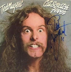 Ted Nugent Signed "Cat Scratch Fever" Album (ACOA Authentication): "Cat Scratch Fever" album signed on the cover in blue felt tip marker by musician Ted Nugent. Measuring approximately 12" x 12" and in fine condition. Accompanied by an ACOA COA (#SA60575).