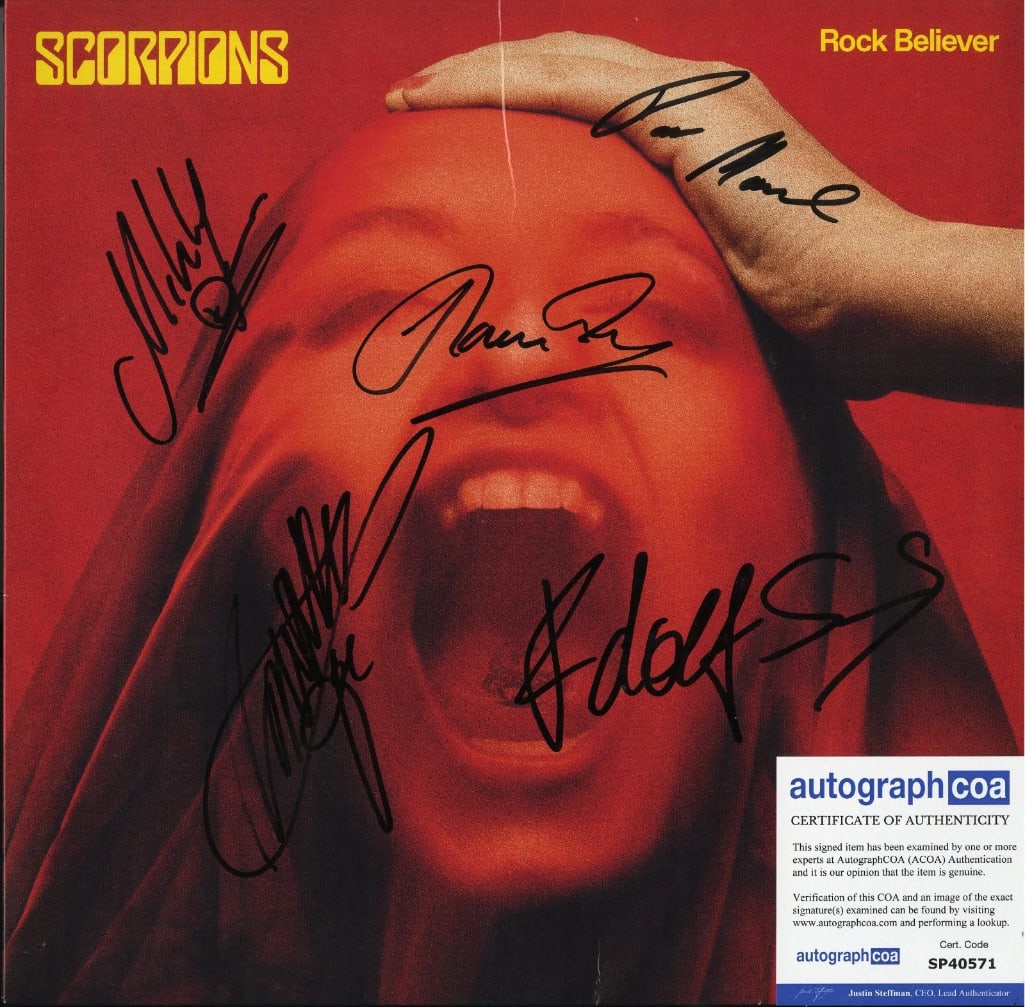 Scorpions Fully Group Signed "Rock Believer" Album (5 Sigs) (ACOA Authentication): "Rock Believer" album signed in black felt tip marker by Scorpions band members Rudolph Schenker, Klaus Meine, Matthias Jabs, Mikkey Dee, and Pawel Maciwonda. Measuring approximately 12" x 12" and in 