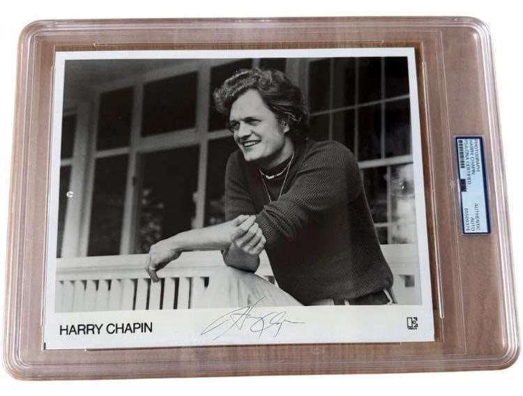 Harry Chapin Signed 8" x 10" Press Photo (PSA/DNA Encapsulated): Scarce black-and-white 8" x 10" press photo signed in black ballpoint pen by Harry Chapin. In fine condition. Encapsulated and authenticated by PSA/DNA (#85509374). A desirable signed image of the