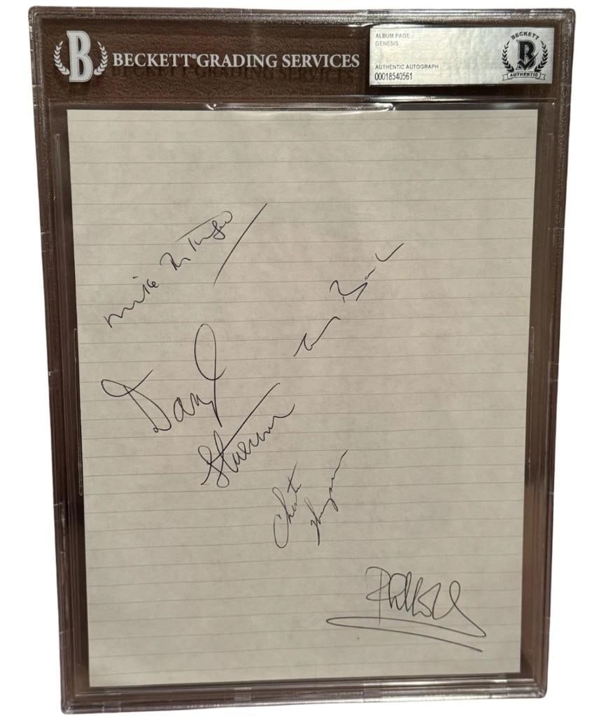 Genesis Group Signed 10" x 7.5" Album Page (5 Sigs) (Beckett Encapsulated): White lined 10" x 7.5" album page signed in black ballpoint pen by Genesis band members Mike Rutherford, Tony Banks, Phil Collins, Chester Thompson, and Daryl Stuermer. In fine condition. Encapsulated