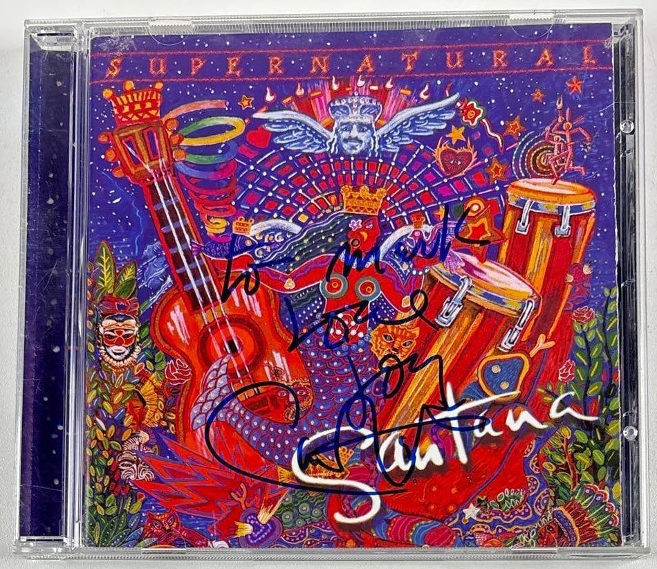 Santana: Carlos Santana Signed "Supernatural" CD (Third Party Guaranteed): "Supernatural" CD signed on the cover in blue felt tip marker by Santana front man Carlos Santana, who inscribed "To Mark" before his signature. Measuring approximately 5" x 5" and in fine condition. 
