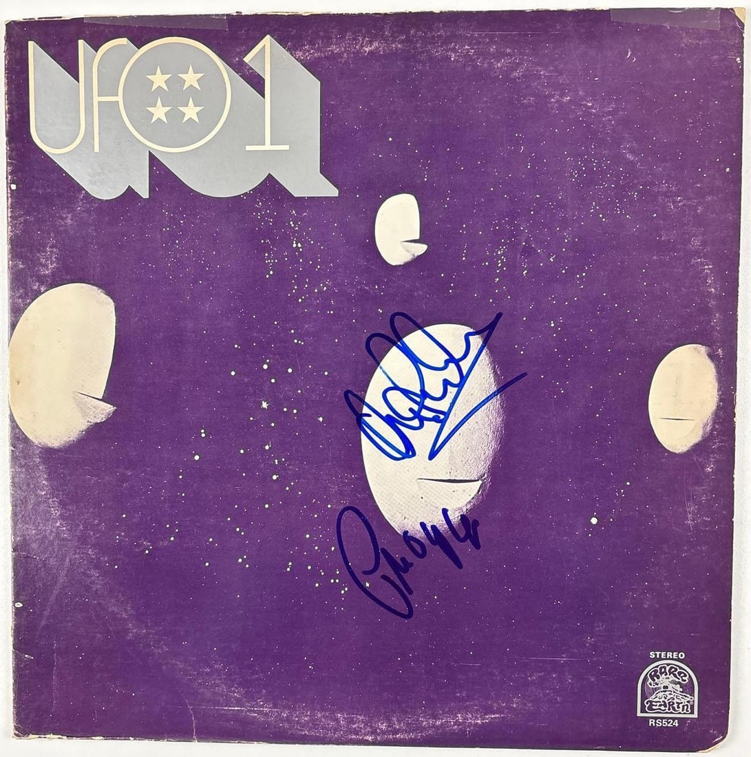 UFO: Andy Parker & Phil Mogg Signed "UFO1" Album (2 Sigs) (Beckett Authentication): "UFO1" album signed on the cover in blue felt tip marker by UFO band members Andy Parker and Phil Mogg. Measuring approximately 12" x 12" and in very good condition, with some signs of scattered