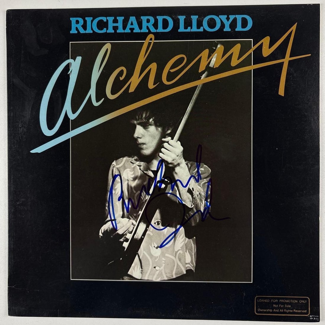 Television: Richard Lloyd Signed "Alchemy" Album (Beckett Authentication): "Alchemy" album signed on the cover in blue felt tip marker by Television band member Richard Lloyd. Measuring approximately 12" x 12" and in fine condition. Record is included. Obtained in-person.