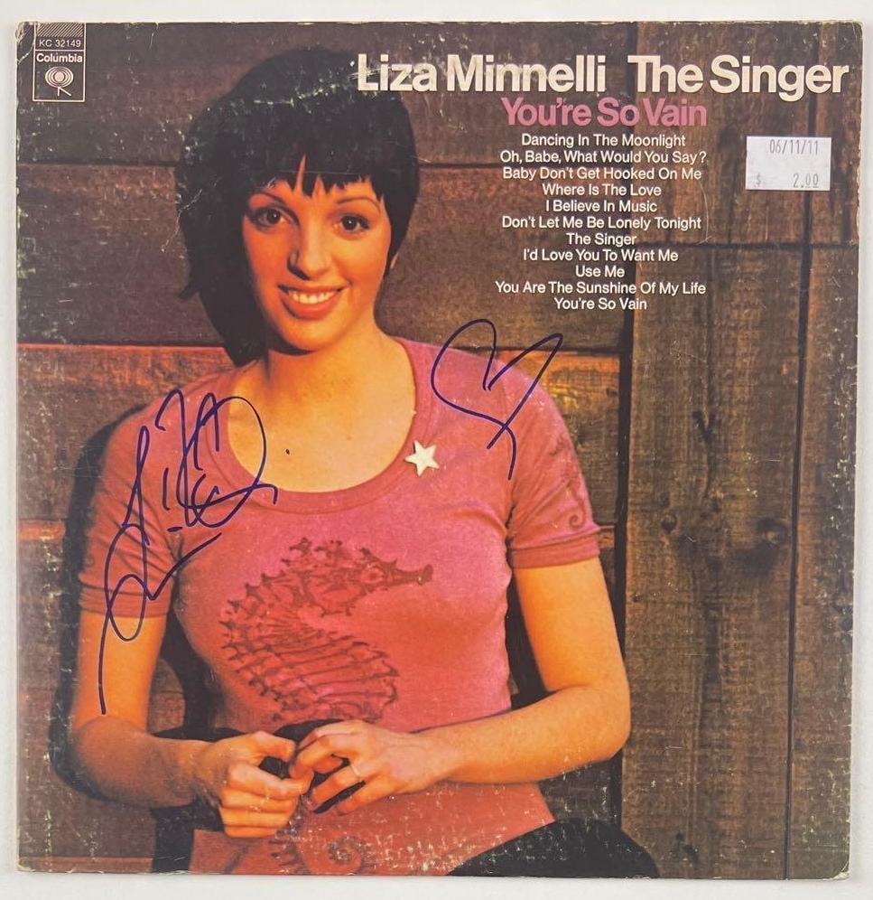 Liza Minelli Signed "The Singer" Album (Beckett Authentication): "The Singer" album signed on the cover in blue felt tip marker by musician and actress Liza Minelli. Measuring approximately 12" x 12" and in very good condition, with some signs of scattered wear.