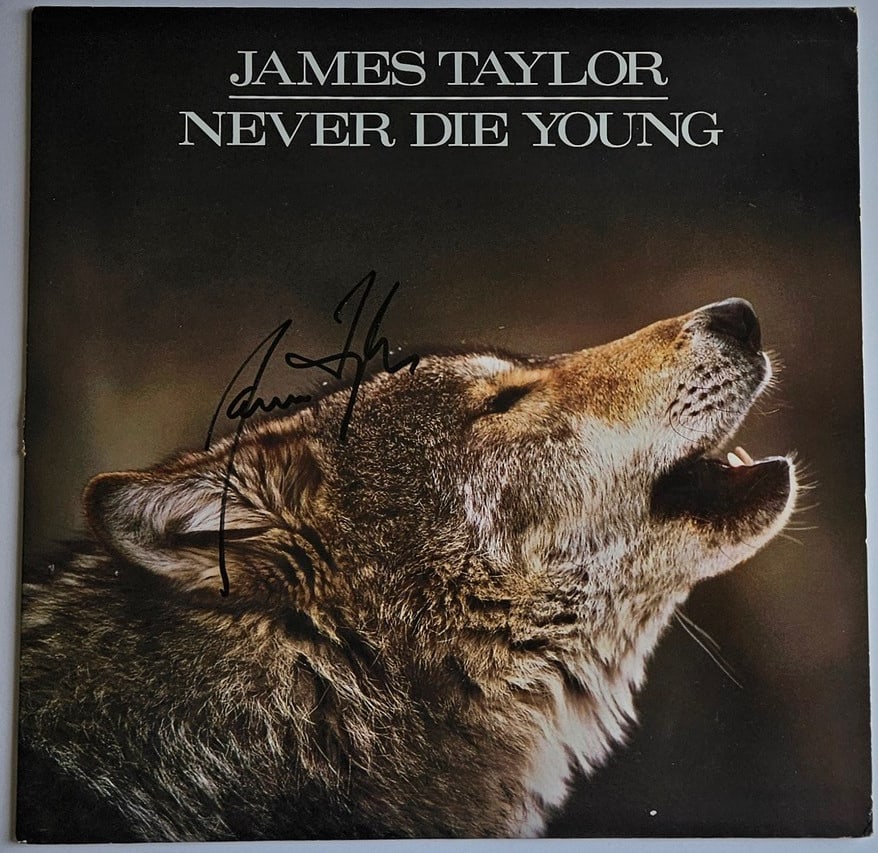 James Taylor Signed "Never Die Young" Album (Third Party Guaranteed): "Never Die Young" album signed on the cover in black felt tip marker by musician James Taylor. Measuring approximately 12" x 12" and in fine condition. Record is included. Provenance Eaton & Brennan A