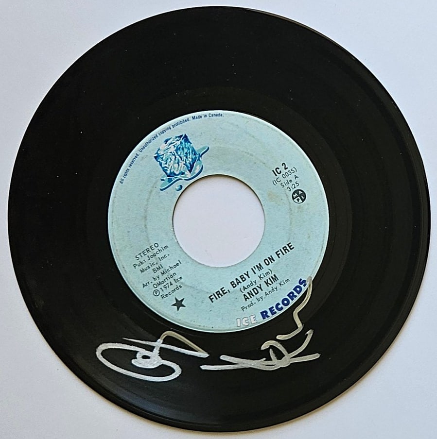 Andy Kim Signed "Fire, Baby I'm on Fire" 45 (Third Party Guaranteed): "Fire, Baby I'm on Fire" 45 signed on the record disc front in silver felt tip marker by musician Andy Kim. Measuring approximately 7" x 7" and in fine condition. Provenance Eaton & Brennan Auctions g