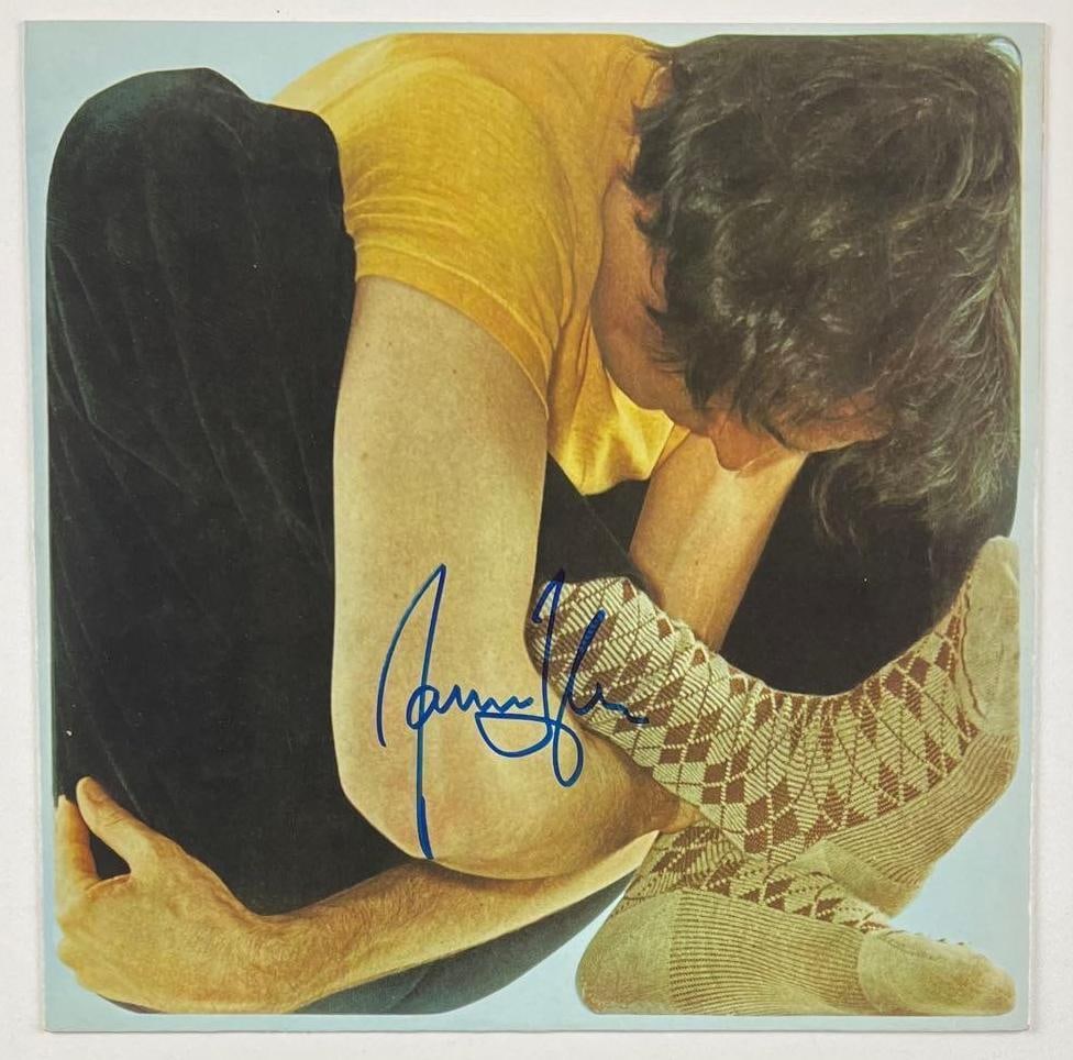 James Taylor "JT" Album Signed on Inner Record Sleeve (Beckett/BAS Authentication): "JT" album signed on the inner record sleeve in blue felt tip marker by musician James Taylor. Measuring approximately 12" x 12" and in fine condition. Record is not included. Obtained in-person.