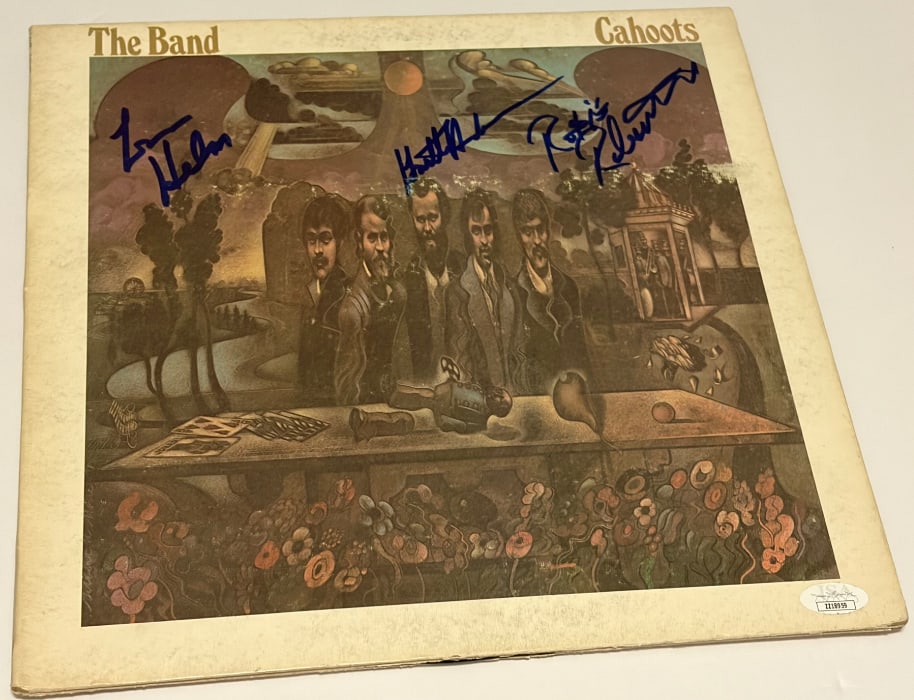 The Band Group Signed "Cahoots" LP Album (3 Sigs) (JSA Authentication): "Cahoots" LP album signed on the cover in blue felt tip marker by The Band band members Leon Helm, Robbie Robertson, and Garth Hudson. Measuring approximately 12" x 12" and in very good condition, wit