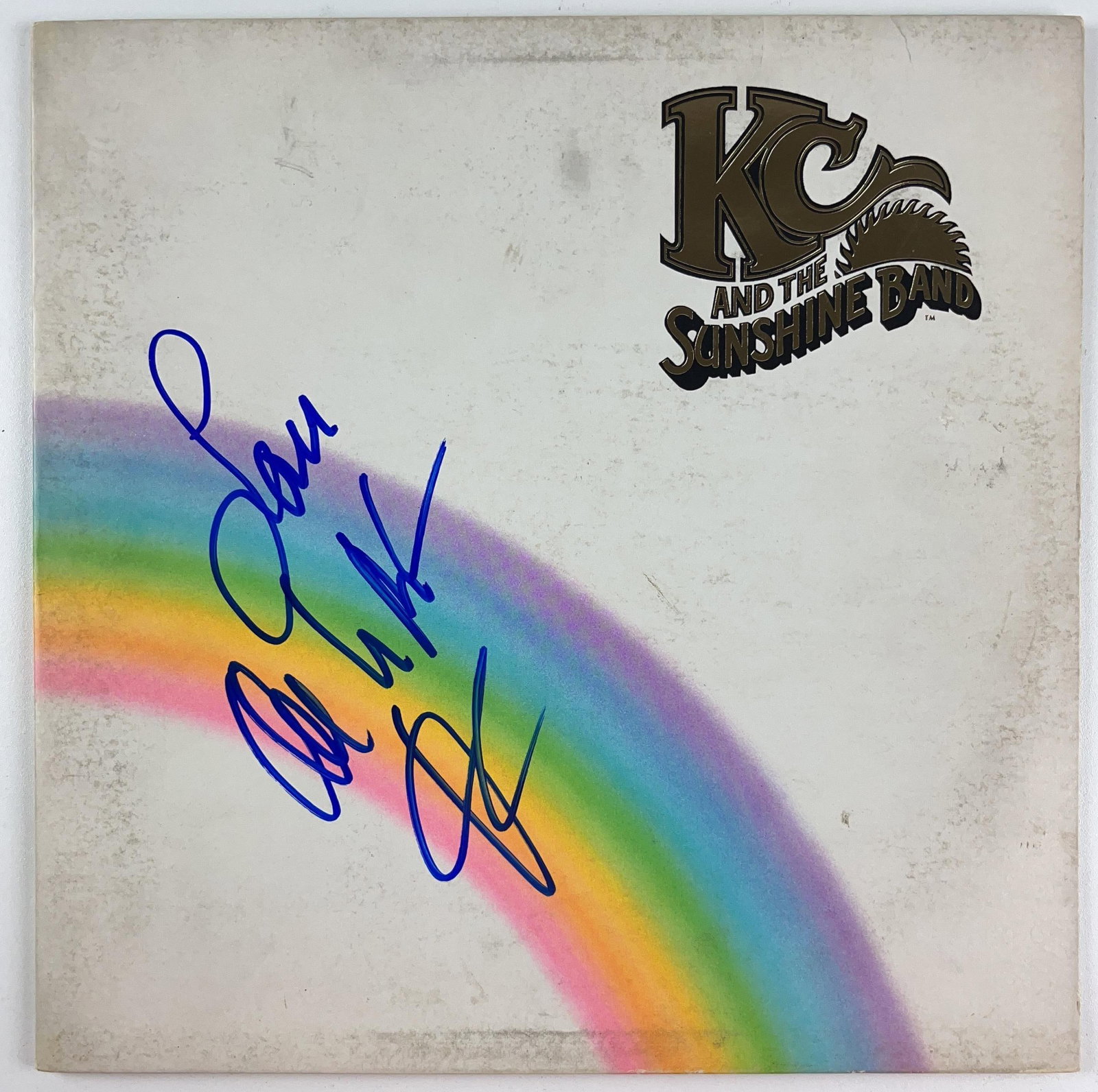 KC and the Sunshine Band: Harry Wayne Casey Signed Self-Titled Album (Beckett): "KC and the Sunshine Band" album signed on the cover in blue felt tip marker by KC and the Sunshine front man Harry Wayne Casey, who inscribed "Love" before his signature. Measuring approximately 12" 