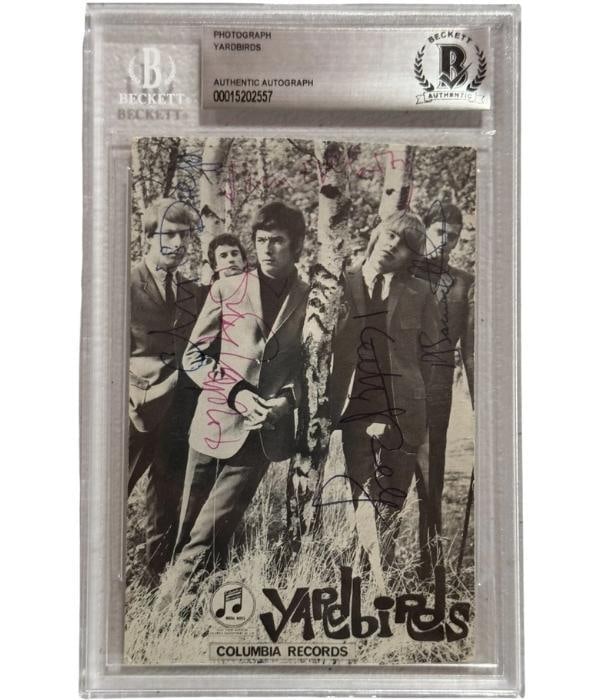The Yardbirds Group Signed Postcard Photo (5 Sigs) (Beckett): Attractive black-and-white 6" x 4" postcard photo signed in blue and black ballpoint pens by the Yardbirds band members James McCarty, Chris Dreja, Keith Relf, Eric Clapton, and Paul Samwell Smith. In