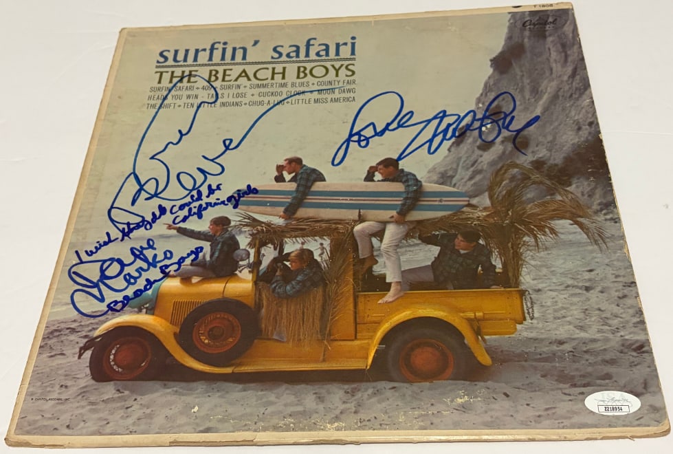 The Beach Boys Group Signed "Surfin' Safari" LP Album (3 Sigs) (JSA Authentication): "Surfin' Safari" LP album signed on the cover in blue felt tip marker by the Beach Boys band members Brian Wilson, Mike Love, and David Marks. Cover also has inscriptions "I wish they could all be
