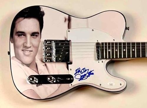 Elvis Presley: James Burton In-Person Signed Custom Tele-Style Guitar (JSA Authentication): Custom-designed Tele-style electric guitar featuring a portrait of Elvis Presley, signed on the pickguard in blue felt tip marker by James Burton, legendary guitarist and longtime bandleader for