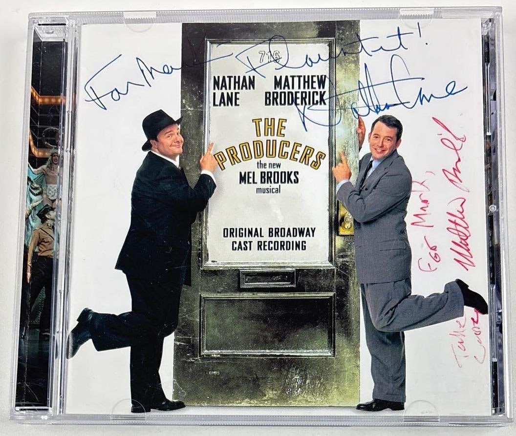 Nathan Lane & Matthew Broderick Signed "The Producers" Soundtrack CD (2 Sigs): "The Producers" soundtrack CD signed on the cover in blue and red ballpoint pens by actors Nathan Lane, who inscribed "For Mark Flaunt it!" before his signature, and Matthew Broderick, who inscribed "