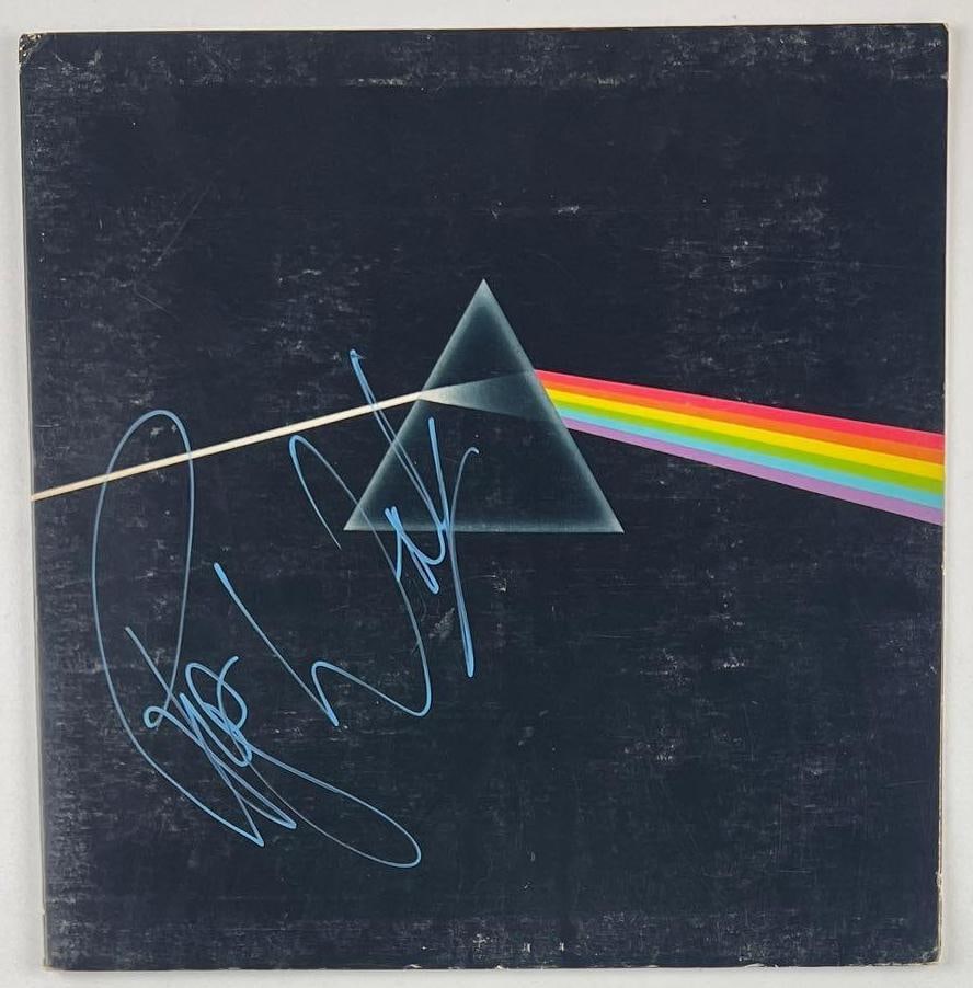 Pink Floyd: Roger Waters Signed "Dark Side of the Moon" Album (Beckett Authentication): "Dark Side of the Moon" album signed on the cover in blue paint pen by Pink Floyd band member Roger Waters. Measuring approximately 12" x 12" and in very good condition, with some signs of scattered w