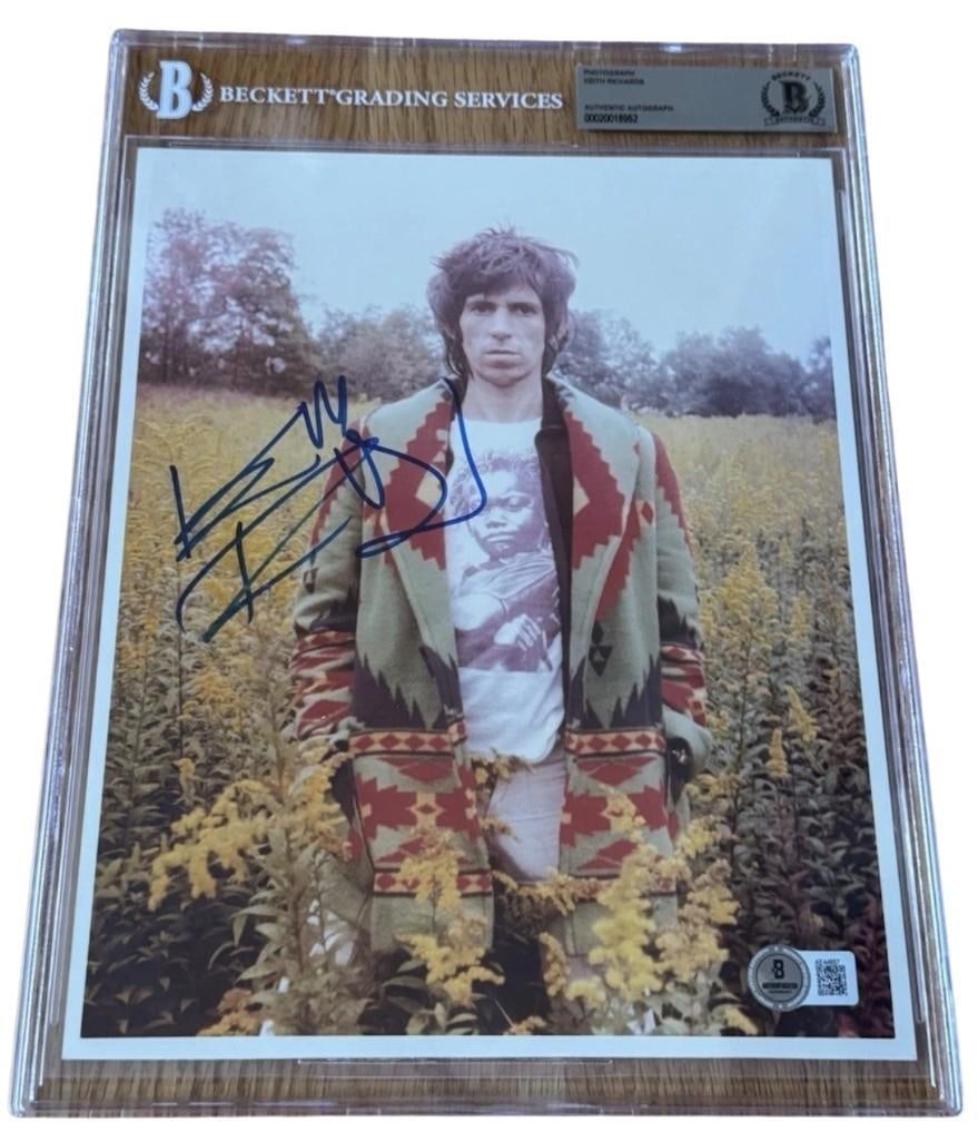The Rolling Stones: Keith Richards Signed 10" x 8" Photo (Beckett Encapsulated): Uncommon color 10" x 8" photo signed in blue felt tip marker by the Rolling Stones band member Keith Richards. In fine condition. Encapsulated and authenticated by Beckett (#00020018962). An outstandi