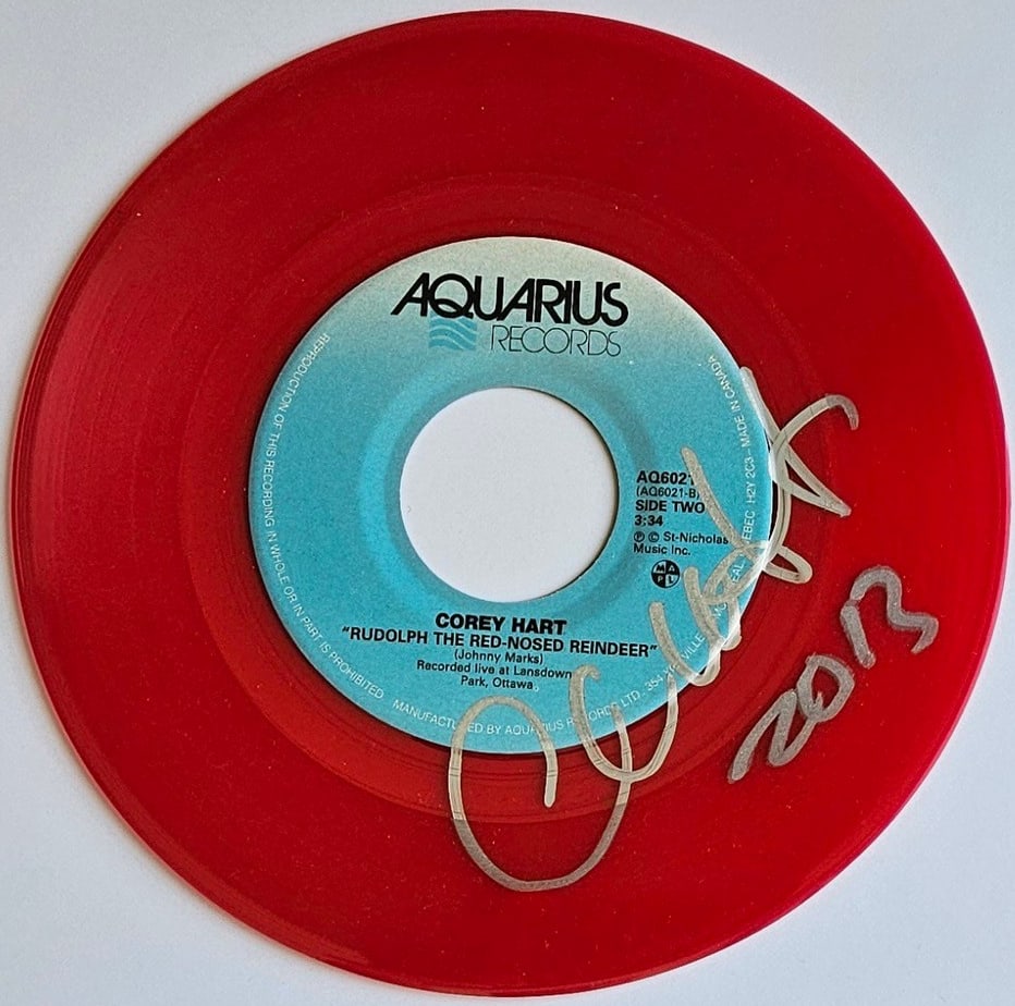 Corey Hart Signed "Rudolph the Red-Nosed Reindeer" 45 (Third Party Guaranteed): "Rudolph the Red-Nosed Reindeer" 45 signed on the record disc front in silver felt tip marker by musician Corey Hart, who also inscribed the date "2013" after his signature. Measuring approximately
