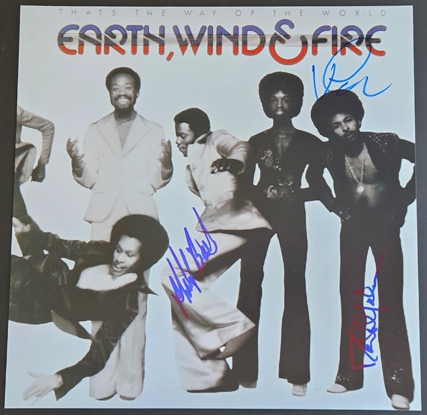 Earth, Wind & Fire Group Signed 12" x 12" Promo Photo (3 Sigs) (Third Party Guaranteed): Color 12" x 12" promotional "That's the Way of the World" photo signed in blue felt tip marker by Earth, Wind & Fire band members Verdine White, Philip Bailey, and Ralph Johnson. In fine condition.