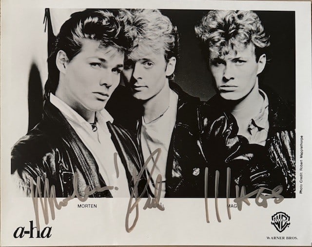 A-ha Fully Signed 8"x 10" Promo Photo (3 Sigs) (Third Party Guaranteed): Black-and-white 8" x 10" promotional photo signed in silver felt tip marker by A-ha band members Paul Waakataa-Savoy, Magne Furuholmen, and Morten Harket. In fine condition. Provenance Eaton & Brennan