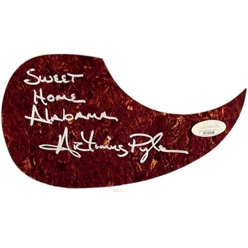 Lynyrd Skynyrd: Artimus Pyle Signed Acoustic Guitar Pickguard (JSA Authentication): Brown 5" x 8.5" acoustic guitar pickguard signed in silver felt tip marker by Lynyrd Skynyrd band member Artimus Pyle, who also inscribed "Sweet Home Alabama" before his signature. In fine condition. 