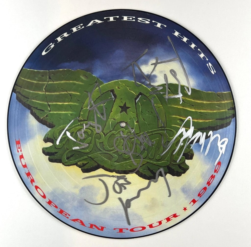 Aerosmith Fully Group Signed "Greatest Hits" Picture Disc (5 Sigs) (JSA Authentication): "Greatest Hits" picture disc signed on the front in silver felt tip marker by Aerosmith band members Steven Tyler, Joe Perry, Brad Whitford, Tom Hamilton, and Joey Kramer. Measuring approximately 12" 