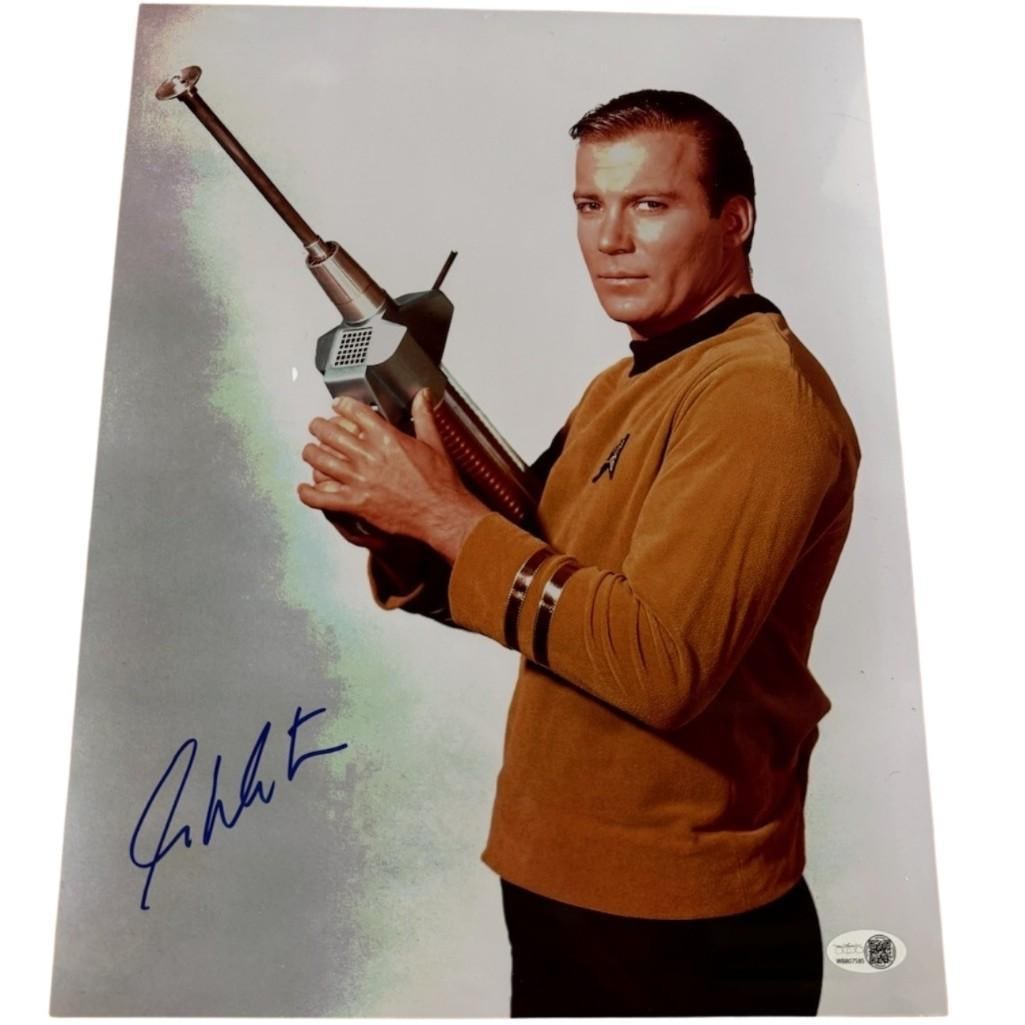Star Trek: William Shatner Signed 14" x 11" Photo as Captain Kirk (JSA Authentication): Color 14" x 11" photo of the character Captain Kirk from the television show "Star Trek" signed in blue felt tip marker by actor William Shatner. In fine condition. Authenticated by JSA, with their