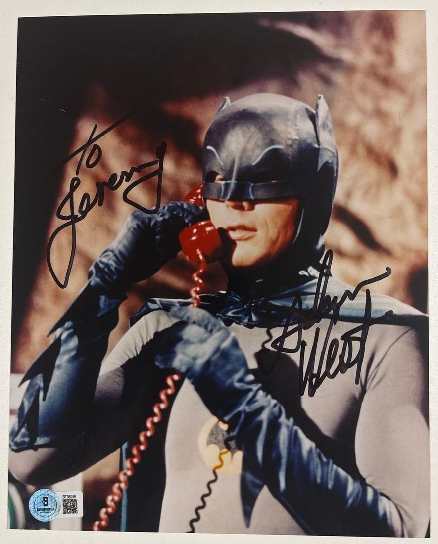 Batman: Adam West Signed 10" x 8" Photo as Batman (Beckett Authentication): Color 10" x 8" photo of the character Batman from the television show "Batman" signed in black felt tip marker by actor Adam West, who also inscribed "To Jeremy" before his signature. In fine