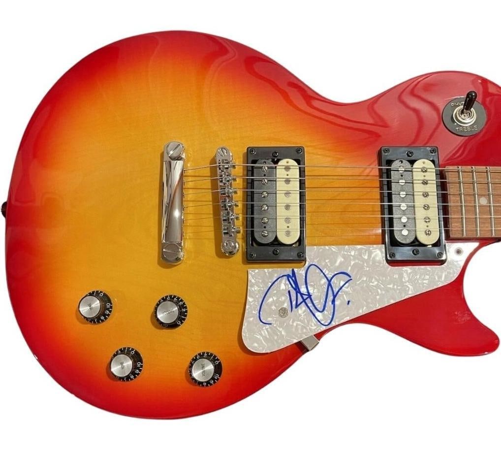 Led Zeppelin: Robert Plant Signed Les Paul-Style Electric Guitar (Beckett & JSA Authentication): Red-to-orange sunburst Les Paul-style electric guitar signed on the pearloid pickguard in blue felt tip marker by Led Zeppelin band member Robert Plant. Measuring approximately 17.5" x 38" and in fine
