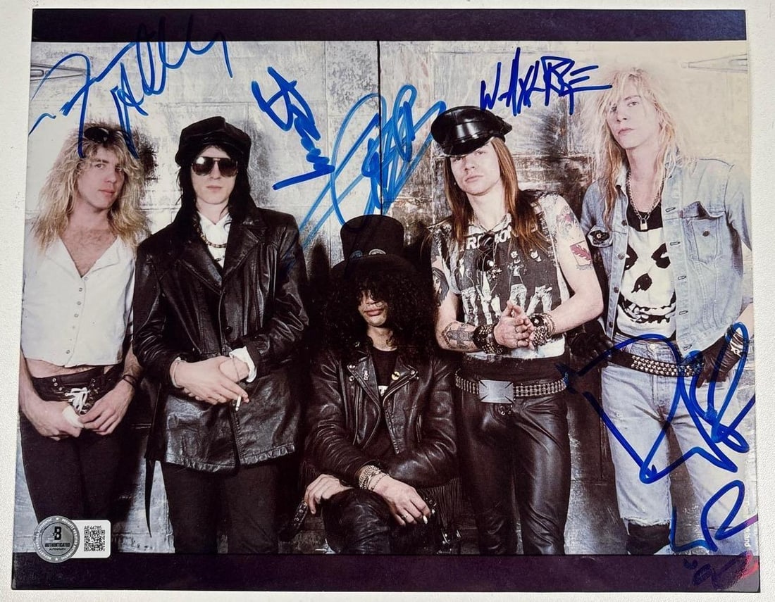 Guns N' Roses Group Signed 8" x 10" Photo (5 Sigs) (Beckett Authentication): Color 8" x 10" photo signed in blue felt tip marker by Guns N' Roses band members Axl Rose, Slash, Duff McKagan, Izzy Stradlin, and Steven Adler. In fine condition. Obtained in-person. Authenticated b
