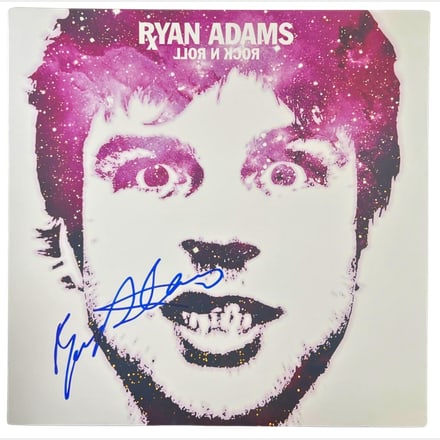 Ryan Adams Signed "Rock N Roll" Album (Beckett Authentication): "Rock N Roll" album signed on the cover in blue felt tip marker by musician Ryan Adams. Measuring approximately 12" x 12" and in fine condition. Record is included. Obtained in-person. Accompanied by