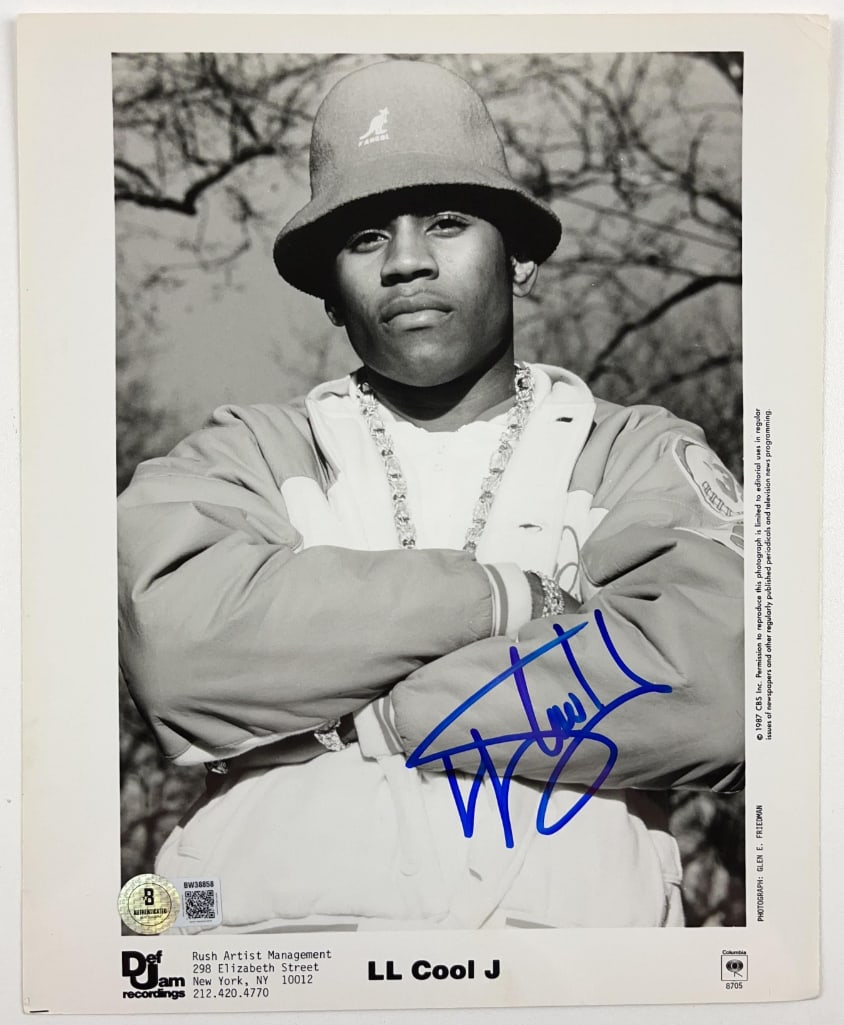 LL Cool J. Signed 10" x 8" Promo Photo (Beckett Authentication): Black-and-white 10" x 8" promotional photo signed in blue felt tip marker by rapper LL Cool J.. In fine condition. Obtained in-person. Authenticated by Beckett, with their official hologram affixed