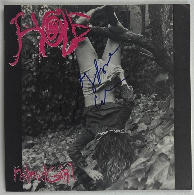 Hole: Courtney Love Signed "Retard Girl" 45 (Beckett Authentication): "Retard Girl" 45 signed on the cover in blue felt tip marker by Hole band member Courtney Love. Measuring approximately 7" x 7" and in fine condition. Record is included. Accompanied by a Beckett COA