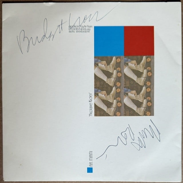 Air Miami Group Signed "Airplane Rider" 45 (2 Sigs) (Third Party Guaranteed): "Airplane Rider" 45 signed on the cover in blue ballpoint pen by Air Miami band members Mark Robinson and Bridget Cross. Measuring approximately 7" x 7" and in fine condition. Record is included.